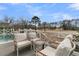 Outdoor patio seating area overlooks manicured backyard and adjacent golf course at 151 Brailsford St, Charleston, SC 29492