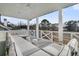 Covered outdoor patio with white furniture and a peaceful view at 151 Brailsford St, Charleston, SC 29492