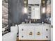 Chic powder room with custom vanity, marble countertop, and designer fixtures at 151 Brailsford St, Charleston, SC 29492
