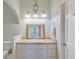 Bright bathroom with a granite counter, decorative mirror, and modern vanity lighting at 1860 Pinopolis Rd, Pinopolis, SC 29469