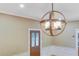 View of a dining room with unique light fixture, hardwood floors, and paneled wooden door at 1860 Pinopolis Rd, Pinopolis, SC 29469