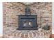 Close-up of a charming brick fireplace with a rustic wood-burning stove, perfect for cold nights at 1860 Pinopolis Rd, Pinopolis, SC 29469