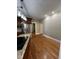 Open kitchen area with stainless steel refrigerator and hardwood flooring, adjacent to hallway at 1860 Pinopolis Rd, Pinopolis, SC 29469