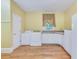Functional laundry room with washer, dryer, ample cabinet space, and a convenient sink near a window at 1860 Pinopolis Rd, Pinopolis, SC 29469