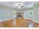 Inviting living room with a brick fireplace and natural light from the window at 1860 Pinopolis Rd, Pinopolis, SC 29469