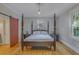 Charming main bedroom with wooden floors, canopy bed, and sliding barn door at 1860 Pinopolis Rd, Pinopolis, SC 29469