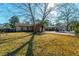Spacious front yard with mature trees shading a charming single-story home at 204 E Edgefield Dr, Summerville, SC 29483