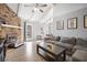 Cozy living room with a brick fireplace, wood floors, and natural light at 204 E Edgefield Dr, Summerville, SC 29483
