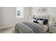 Cozy bedroom featuring a comfortable bed with stylish bedding, soft lighting, and neutral decor at 207 Denham St, Summerville, SC 29486