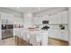 Modern white kitchen with an island, stainless steel appliances, and stylish countertops at 207 Denham St, Summerville, SC 29486