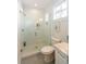 Bathroom featuring a glass-enclosed shower, tiled walls, and vanity with natural light at 22 1/2 Mary St # A B C, Charleston, SC 29403