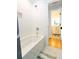 Bathroom with a white subway-tiled shower and adjacent vanity, offering a serene and bright space at 22 1/2 Mary St # A B C, Charleston, SC 29403