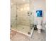 Elegant bathroom featuring a glass-enclosed shower, modern fixtures, and decorative tile work, with complementary artwork and accessories at 22 1/2 Mary St # A B C, Charleston, SC 29403