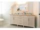 Bathroom with a dual sink vanity, marble countertop, and decorative mirror at 22 1/2 Mary St # A B C, Charleston, SC 29403