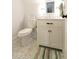 Cozy bathroom featuring a toilet and a vanity with marble countertop and a sleek, framed mirror at 22 1/2 Mary St # A B C, Charleston, SC 29403