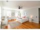 Bright bedroom featuring hardwood floors, large windows, and stylish decor at 22 1/2 Mary St # A B C, Charleston, SC 29403