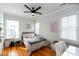 Charming bedroom with hardwood floors, three windows and a ceiling fan at 22 1/2 Mary St # A B C, Charleston, SC 29403