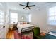 Cozy bedroom with a metal frame bed, vibrant rug, and abundant natural light at 22 1/2 Mary St # A B C, Charleston, SC 29403
