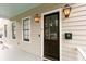 Attractive front entrance featuring a dark wood door, framed by sidelight windows and stylish lantern lighting, with a welcoming atmosphere at 22 1/2 Mary St # A B C, Charleston, SC 29403