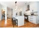 Bright kitchen with white cabinetry, stainless steel appliances, and an island with seating at 22 1/2 Mary St # A B C, Charleston, SC 29403