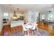 Open concept kitchen with stainless steel appliances and hardwood floors leading to dining area at 22 1/2 Mary St # A B C, Charleston, SC 29403