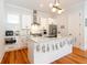 Bright kitchen with white cabinetry, stainless steel appliances, and a large kitchen island at 22 1/2 Mary St # A B C, Charleston, SC 29403