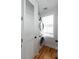 A modern laundry room featuring a stacked washer and dryer unit, white cabinets, and a bright window at 22 1/2 Mary St # A B C, Charleston, SC 29403