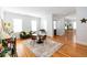 Bright living room featuring hardwood floors, a dining table and white walls at 22 1/2 Mary St # A B C, Charleston, SC 29403