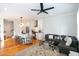 Open-concept living area with modern kitchen, island seating, and comfortable seating area at 22 1/2 Mary St # A B C, Charleston, SC 29403