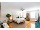 Sunlit main bedroom with decorative headboard, ceiling fan and hardwood floors at 22 1/2 Mary St # A B C, Charleston, SC 29403