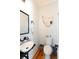 Quaint powder room with vessel sink, wood floors, and decorative starfish net at 22 1/2 Mary St # A B C, Charleston, SC 29403