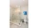Beautiful bathroom featuring a glass-enclosed shower with modern fixtures, tiled walls, and mosaic flooring at 22 1/2 Mary St # A B C, Charleston, SC 29403