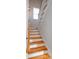 Bright stairway features hardwood treads, white risers and railings, plus a window for natural light at 22 1/2 Mary St # A B C, Charleston, SC 29403
