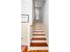 Wooden staircase with white risers leading to the upper level of the home at 22 1/2 Mary St # A B C, Charleston, SC 29403