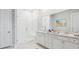 Elegant bathroom with double vanity sinks, walk-in shower with glass door, and white marble-style floors at 230 Denham St, Summerville, SC 29486