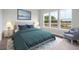 Cozy bedroom featuring a large bed, nightstands, and a window overlooking the yard at 230 Denham St, Summerville, SC 29486