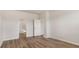 Open bedroom with wood-look floors and doors to adjacent rooms at 287 Blue Haw Dr, Moncks Corner, SC 29461