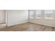 Bright, airy bedroom featuring wood-look flooring and three windows for ample natural light at 287 Blue Haw Dr, Moncks Corner, SC 29461