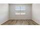 Neutral bedroom with a window, showcasing natural light and modern wood-look flooring at 287 Blue Haw Dr, Moncks Corner, SC 29461