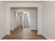 Bright entryway with wood-look floors leads to staircase, with a view of the hall and a white color scheme at 287 Blue Haw Dr, Moncks Corner, SC 29461