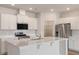 Bright, modern kitchen boasts a central island, stainless steel appliances, and white cabinets with wood-look floors at 287 Blue Haw Dr, Moncks Corner, SC 29461