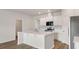 A kitchen featuring a large island, stainless steel appliances, and white cabinets with modern wood-look floors at 287 Blue Haw Dr, Moncks Corner, SC 29461