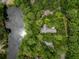 Aerial view highlighting the property boundaries of the home surrounded by mature trees and a serene pond at 2932 Old Drake Dr, Seabrook Island, SC 29455