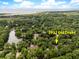 Expansive aerial view of the property's location at 2932 Old Drake amidst lush greenery and nearby water features at 2932 Old Drake Dr, Seabrook Island, SC 29455