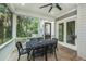 Enjoy the outdoors from this spacious screened porch featuring comfortable seating, ceiling fans, and scenic views at 2932 Old Drake Dr, Seabrook Island, SC 29455