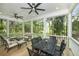 Relaxing screened-in back porch with comfortable seating, outdoor dining area, and views of the surrounding nature at 2932 Old Drake Dr, Seabrook Island, SC 29455