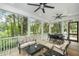 Relaxing screened-in back porch with comfortable seating, outdoor dining area, and views of the surrounding nature at 2932 Old Drake Dr, Seabrook Island, SC 29455
