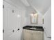 A modern half bathroom featuring a white door and vanity with dark countertop at 2932 Old Drake Dr, Seabrook Island, SC 29455