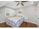 Bedroom with white furniture, ceiling fan, hardwood floors, and nautical decor at 2932 Old Drake Dr, Seabrook Island, SC 29455