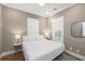 Bedroom features a ceiling fan, hardwood floors, shuttered windows, and simple decor for a calm setting at 2932 Old Drake Dr, Seabrook Island, SC 29455